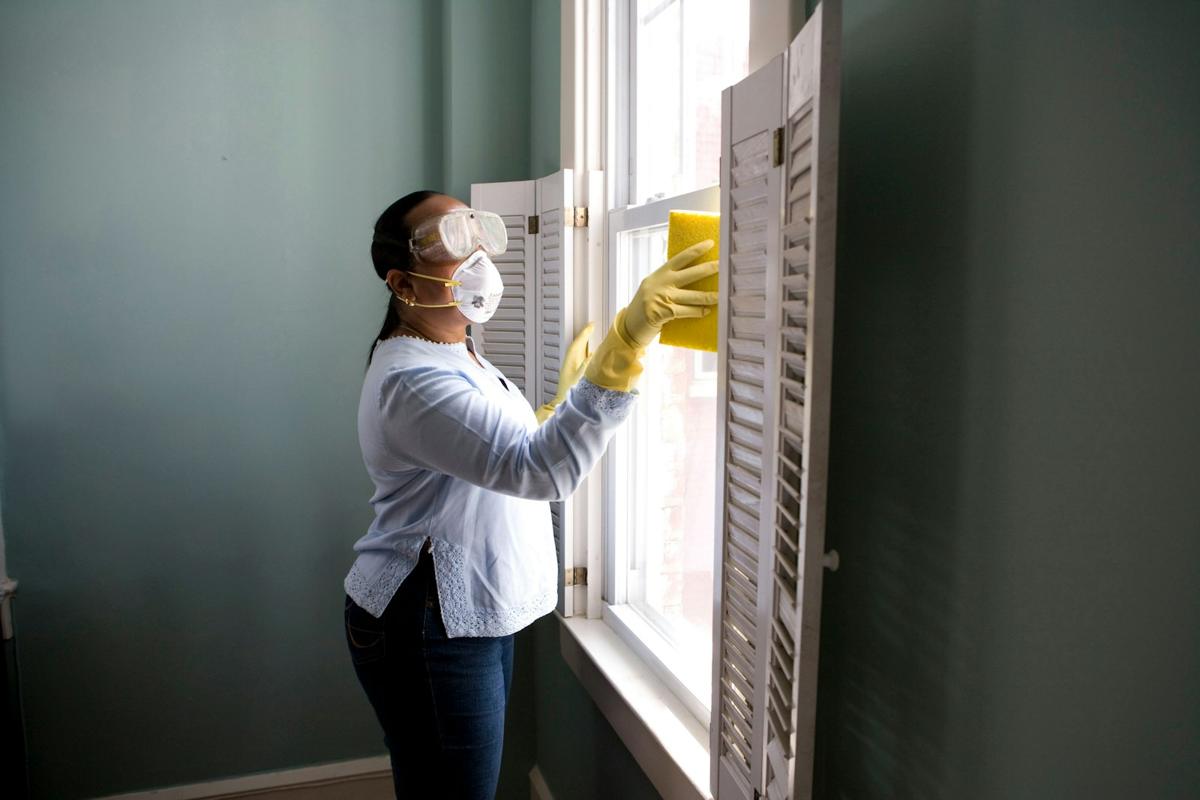 Cleaner wiping a bright window